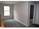 Bedroom with neutral paint, carpet flooring, window and door to another room at 253 Woodland Way, Canton, GA 30114
