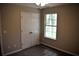 Bedroom with neutral walls, carpet, closet, and a window at 253 Woodland Way, Canton, GA 30114
