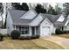 Charming home featuring vinyl siding, a one-car garage, and a well-manicured lawn at 253 Woodland Way, Canton, GA 30114