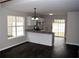 Bright kitchen with granite countertops, white cabinets and modern appliances, and dark hardwood floors at 253 Woodland Way, Canton, GA 30114