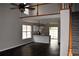 Bright living room flowing into a modern kitchen with granite countertops and dark hardwood floors at 253 Woodland Way, Canton, GA 30114