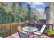 Outdoor deck with table and chairs overlooking lush foliage and trees at 2766 Birch Grove Se Ln # 11, Marietta, GA 30067