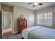 Bedroom includes a window with shutters, carpeted floors, and a wood dresser for ample storage at 2766 Birch Grove Se Ln # 11, Marietta, GA 30067