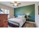 Bedroom boasts a green accent wall, ceiling fan, and shuttered window creating an airy and inviting space at 2766 Birch Grove Se Ln # 11, Marietta, GA 30067
