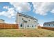 View of the home's backyard with a wooden fence and grassy area on a slightly sloping hill at 4443 Quilter St, Powder Springs, GA 30127