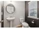 Charming powder room with stylish fixtures, a pedestal sink, and contrasting paint at 4443 Quilter St, Powder Springs, GA 30127