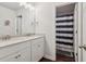 Bathroom with double vanity and shower with curtain at 4443 Quilter St, Powder Springs, GA 30127