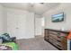 Spacious bedroom featuring a TV, ceiling fan, closet, and dresser at 4443 Quilter St, Powder Springs, GA 30127