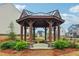 Community gazebo surrounded by landscaping with views of the neighborhood homes beyond at 4443 Quilter St, Powder Springs, GA 30127