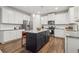 Modern kitchen featuring white cabinetry, stainless steel appliances, and a stylish dark island at 4443 Quilter St, Powder Springs, GA 30127