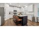 Bright kitchen featuring white cabinets, stainless steel appliances, and a large island with bar stool seating at 4443 Quilter St, Powder Springs, GA 30127