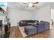 Cozy living room with hardwood floors, a fireplace, and a plush sectional couch, perfect for relaxing at 4443 Quilter St, Powder Springs, GA 30127