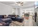 Open-concept living room with a fireplace, a large sectional, and seamless access to the kitchen area at 4443 Quilter St, Powder Springs, GA 30127
