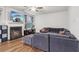 Comfortable living room featuring a fireplace, large sectional couch, and a ceiling fan at 4443 Quilter St, Powder Springs, GA 30127