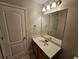 Bathroom featuring a vanity with framed mirror and ample lighting at 100 Iverson Pl, Temple, GA 30179