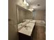 Bright bathroom featuring a double vanity, a large mirror and a bathtub at 100 Iverson Pl, Temple, GA 30179