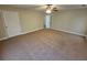 Spacious bedroom featuring plush carpeting, a ceiling fan and a neutral color palette at 100 Iverson Pl, Temple, GA 30179