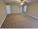 Spacious bedroom with plush carpeting, neutral walls, and natural light from a window at 100 Iverson Pl, Temple, GA 30179