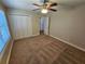 Bedroom with neutral carpeting, ceiling fan, window with blinds and closet at 100 Iverson Pl, Temple, GA 30179