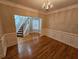 Dining room with hardwood floors, decorative trim and view of the foyer at 100 Iverson Pl, Temple, GA 30179