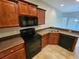 A well-equipped kitchen featuring dark wood cabinetry and modern appliances at 100 Iverson Pl, Temple, GA 30179