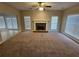 Bright living room featuring a fireplace and great natural light through large windows and french doors at 100 Iverson Pl, Temple, GA 30179