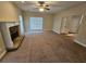Large living room with a cozy fireplace and abundant natural light from large windows at 100 Iverson Pl, Temple, GA 30179