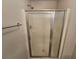 A shower with sliding glass doors and chrome fixtures, ensuring a modern and sleek aesthetic at 100 Iverson Pl, Temple, GA 30179