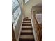 Staircase with carpeted steps and a white railing, offering a smooth transition between floors at 100 Iverson Pl, Temple, GA 30179