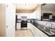 Bright kitchen featuring white cabinets, stainless steel appliances, and dark countertops at 33 Timber Ridge Dr, Cartersville, GA 30121