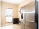 A stainless steel refrigerator in an eat-in-kitchen with large window and tile floors at 33 Timber Ridge Dr, Cartersville, GA 30121