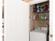 Convenient laundry area with shelving for storage of supplies and a white washer at 33 Timber Ridge Dr, Cartersville, GA 30121