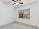 Neutral bedroom featuring a ceiling fan and a large window providing natural light at 1045 Brook Knoll Ln # 401, Cumming, GA 30041