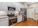 Well-equipped kitchen with stainless steel appliances, white cabinets, and a view of the backyard at 1045 Brook Knoll Ln # 401, Cumming, GA 30041
