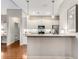 Bright and airy kitchen featuring white cabinets, stainless steel appliances, and seamless connection to living spaces at 1045 Brook Knoll Ln # 401, Cumming, GA 30041