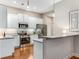 Modern kitchen with white cabinetry, stainless steel appliances, and hardwood floors at 1045 Brook Knoll Ln # 401, Cumming, GA 30041