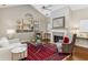 Cozy living room with fireplace, vaulted ceiling, and large window offering natural light at 1045 Brook Knoll Ln # 401, Cumming, GA 30041