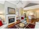 Bright open living space with fireplace, hardwood floors, and view into the kitchen area at 1045 Brook Knoll Ln # 401, Cumming, GA 30041