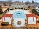 Aerial view of community pool and clubhouse featuring a patio, trellis and fire pit at 1045 Brook Knoll Ln # 401, Cumming, GA 30041