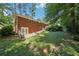 Beautiful backyard with brick house, lush greenery, and stone pathway at 1933 Silvastone Dr, Decatur, GA 30033