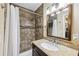 Bathroom featuring a tiled shower, granite countertop vanity, and decorative mirror at 1933 Silvastone Dr, Decatur, GA 30033