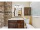 Bathroom featuring a tiled shower, granite countertop vanity, and decorative mirror at 1933 Silvastone Dr, Decatur, GA 30033