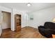 Bedroom featuring hardwood floors, a closet with paneled doors, and a comfortable recliner at 1933 Silvastone Dr, Decatur, GA 30033
