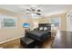 Cozy bedroom featuring hardwood floors, a ceiling fan, and two windows for natural light at 1933 Silvastone Dr, Decatur, GA 30033