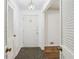 Bright entryway with tiled floor, white walls, and a stylish light fixture at 1933 Silvastone Dr, Decatur, GA 30033
