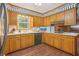 Charming kitchen with wood cabinets and a bright window overlooking the backyard at 1933 Silvastone Dr, Decatur, GA 30033