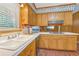 A kitchen featuring wood cabinets and white countertops by the sink with backyard views at 1933 Silvastone Dr, Decatur, GA 30033