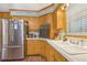 Cozy kitchen featuring stainless steel refrigerator, and wooden cabinetry at 1933 Silvastone Dr, Decatur, GA 30033