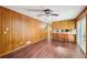 Spacious living room featuring wood paneling and a view of the eat-in kitchen area at 1933 Silvastone Dr, Decatur, GA 30033