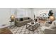 Bright living room with modern furnishings and a view into the formal dining area at 1933 Silvastone Dr, Decatur, GA 30033